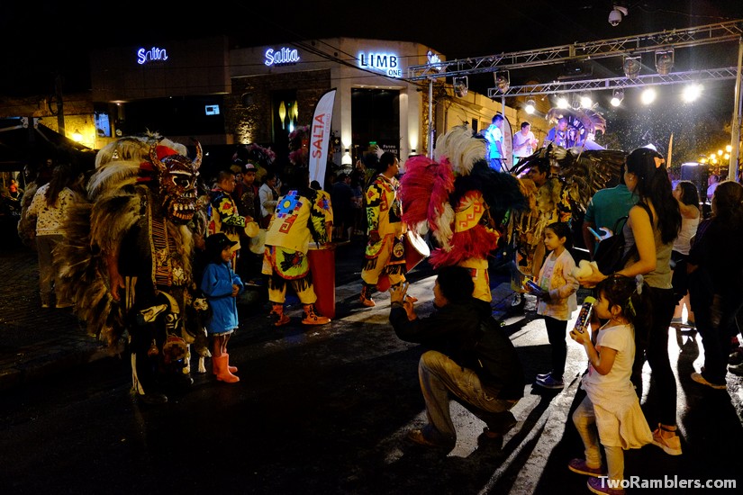 Carnival costumes with big masks, people taking pictures