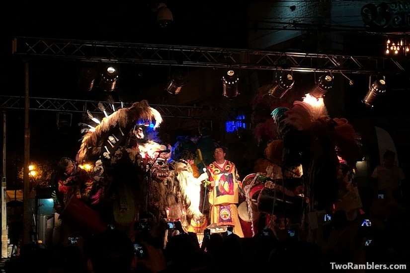 Stage with people in big masks