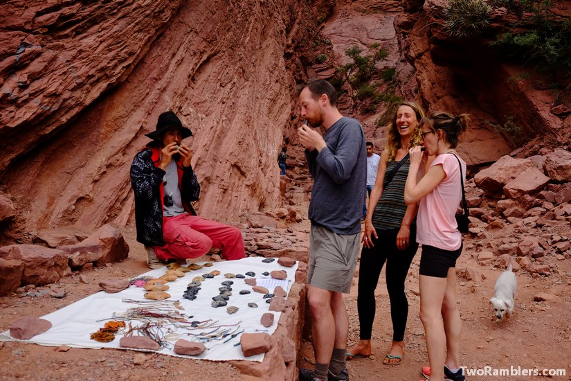 Kevin testing a flute from a stand in front of a gorge