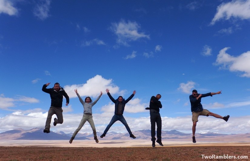 5 persons jumping in desert