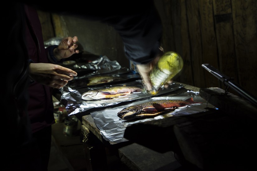 Preparing fish with oil, Refugio Charles, Isla Navarino